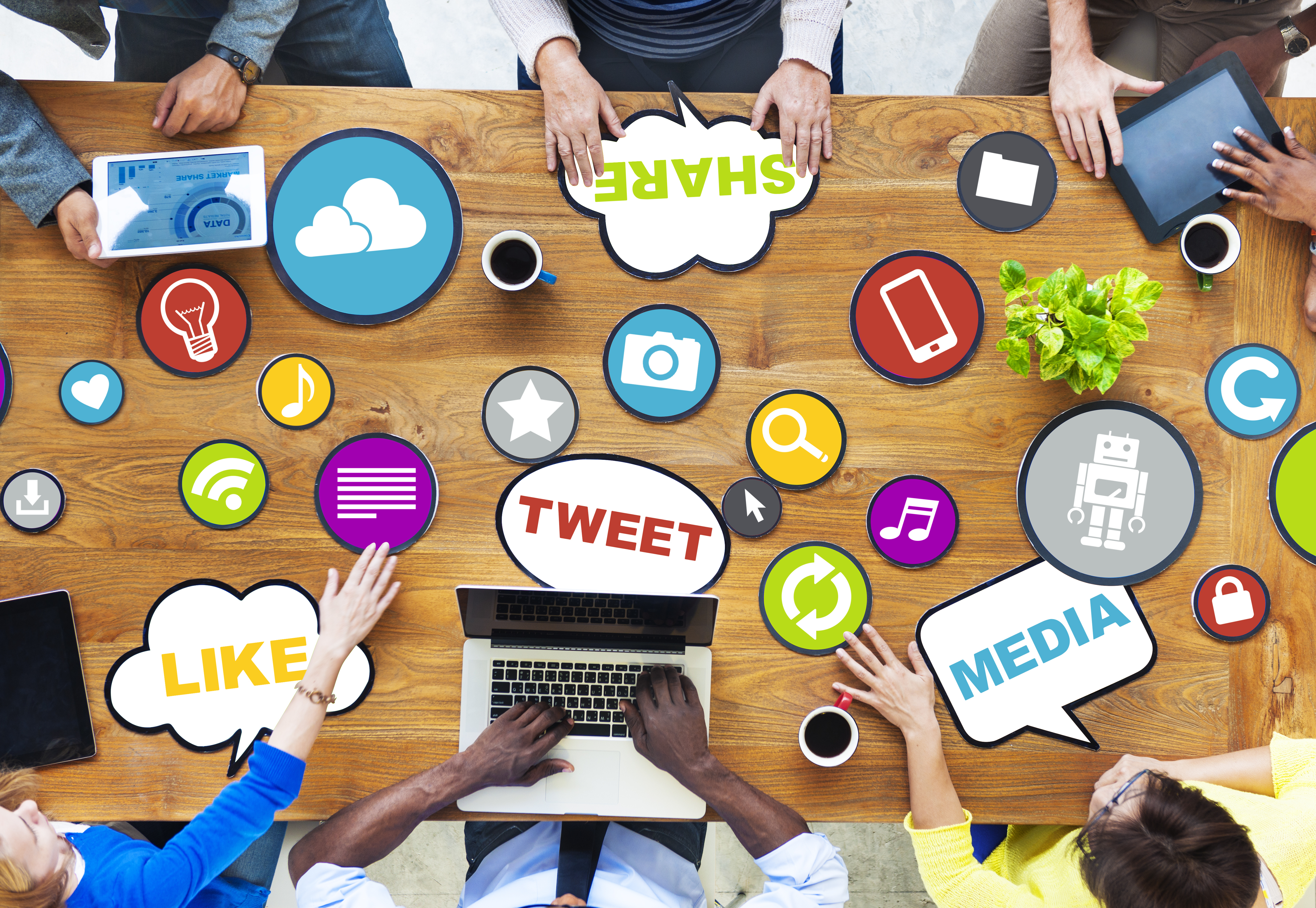 A photo of people around a table on various devices on multiple social media platforms